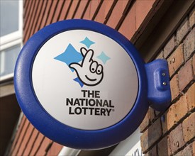 Wall mounted sign for the National Lottery, Amesbury, Wiltshire, England, UK