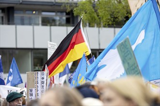 A German flag between peace flags at the Die Waffen nieder demonstration on Breitscheidplatz in