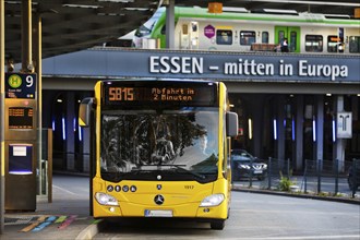 Essener Verkehrsbetriebe bus at the main railway station with local train, public transport,