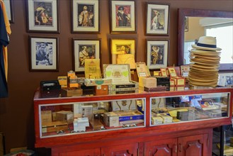 Sale of cigars in a room with portraits and traditional furniture, Bayahibe, Dominican Republic,