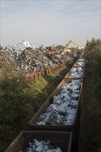 Scrap metal recycling loading train wagons with processed metals, EMR company, Swindon, England, UK