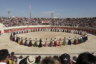 Women dancing in traditional costumes in the arena of Les Saintes Maries de la Mer, Parc Naturel