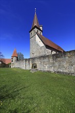 Small Easter fountain in front of the fortified church from the Middle Ages, fortified church,