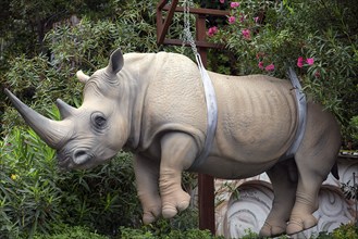 Replica rhinoceros hanging on chains, work of art in the harbour of Portofino Italy