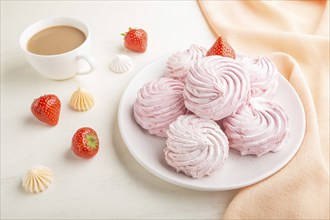 Pink strawberry homemade zephyr or marshmallow with cup of coffee on white wooden background with