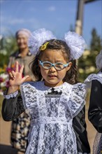 Cool schoolgirl on her first day at school, Issyk-Kul region, Kyrgyzstan, Asia