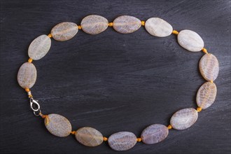 Dragon vein agate colored beads on a black background. top view, close up