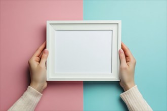 Woman's hands holding white empty picture frame on blue and pink background. Generative Ai, AI