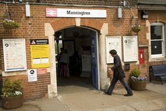 Man walks into Manningtree station entrance, Essex, England, United Kingdom, Europe