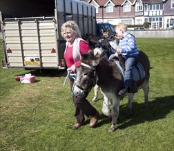 Seaside donkey rides reappear after a gap of fifty years at Felixstowe, Suffolk, England, UK 2010