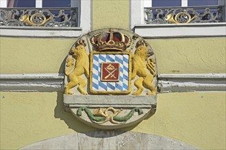 Coat of arms with lion figures, crown and post horn, market square, Feuchtwangen, Middle Franconia,