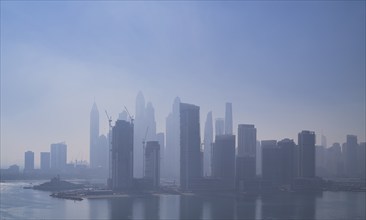 Morning fog, skyline with Princess Tower, Elite Residence, luxury yacht OPERA owned by Sheikh