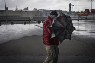 Man with umbrella, Reykjavík, Iceland, Europe