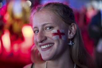 Fan of the English team with a flag on his cheek at the Adidas fan zone at the Bundestag during the