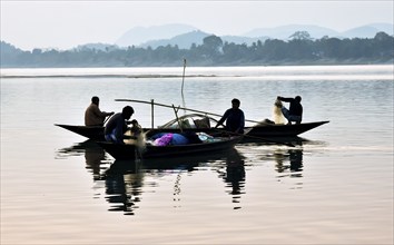 Fishermen lays fishing net at the Brahmaputra River during sunset in Guwahati, Assam, India on