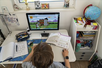 Young, primary school pupils, home learning, doing schoolwork, distance learning, virtual