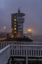 Thick fog in winter, hanging over the mouth of the Elbe into the North Sea, radar tower of the