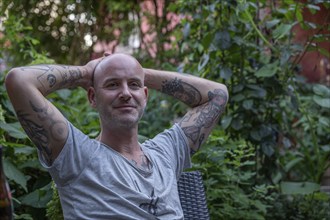 Portrait of a young man with tattooed arms, Baden-Württemberg, Germany, Europe