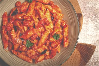 Penne pasta, with shrimp in tomato sauce, close-up, no people