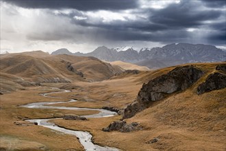 River in front of mountain landscape with yellow meadows, Kol Suu River and mountain peaks, Keltan