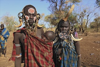 South Ethiopia, in Maco National Park, Mursi tribe, Mursi woman with baby, painted skin and