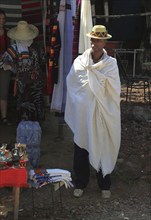 Trader with hat and shawl offers souvenirs, shawls and hats, Ethiopia, Africa