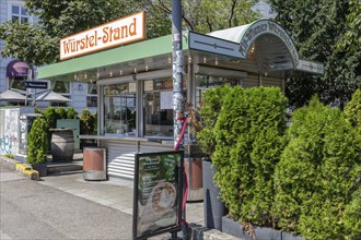 Small snack stand in the city surrounded by plants in sunny weather, Vienna