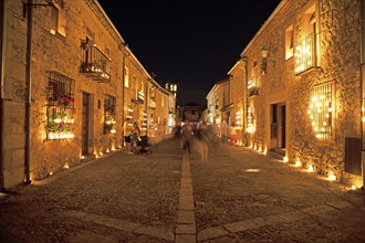 Calle Mayor at night, lit up with candles, Conciertos de las Velas festival of lights, Pedraza,