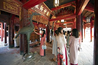 Vietnamese woman at an altar in the Temple of Literature in the Old Quarter of Hanoi, Vietnam, Asia