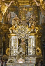 Detailed, baroque statue scene with figure of a saint on a richly decorated altar, cathedral,