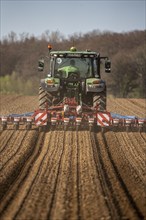 Sugar beet being sown in spring, precision sowing with precision seed drill, behind a tractor,