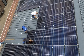 Installation of solar modules on the roof of a barn on a farm, over 210 photovoltaic modules are