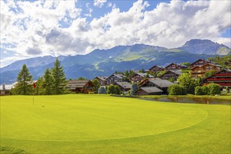 Crans Sur Sierre Golf Course with House and Mountain View in Crans Montana in Valais, Switzerland,