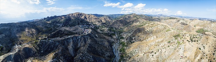 Panorama of Mountains and Olive groves around Ghost Town from a drone, Pentedattilo Village,