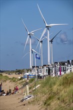 Wind turbines, wind farm, holiday homes, beach houses on the beach of Ijmuiden in North Holland,