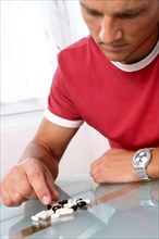 A man takes various tablets, Studio