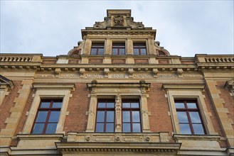 Historic brick façade with ornate windows and architectural details, St. Augustin Grammar School,