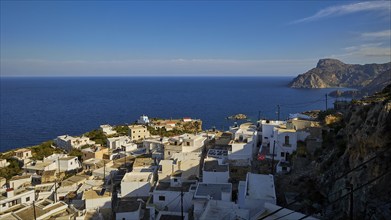 View of a coastal village with whitewashed houses and the sea in the background, Mesochori village,