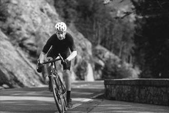 Road bike rider in spring in the Allgäu against the picturesque backdrop of the Alps, Bavaria,