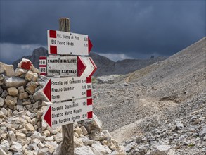 Hiking signpost, upcoming bad weather, dark clouds, dolomites, Italy, Europe