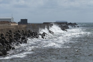 Storm on the offshore island of Heligoland, waves lashing against the western breakwater, tetrapods