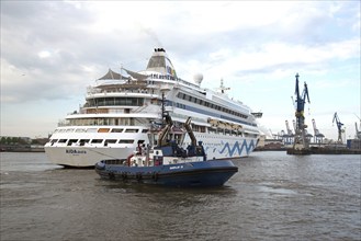 Europe Germany Hanseatic City of Hamburg Harbour Elbe Passenger ship AIDAaura is pulled into dry