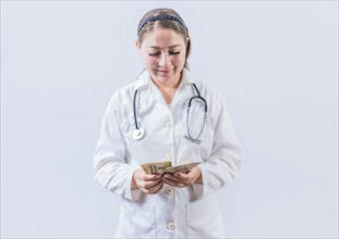 Corrupt female doctor counting money isolated. Female doctor counting banknotes on white background