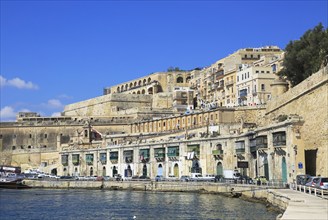 Historic waterfront buildings on Grand Harbour waterside, Valletta, Malta, Europe