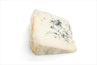 Piece of blue cheese isolated on white background. Side view, close up