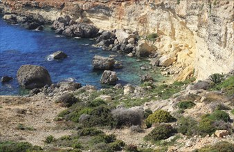 Coastal scenery crumbling cliffs and sea near Cirkewwa, Republic of Malta