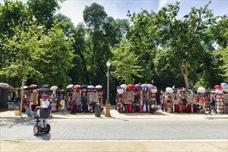 Stalls with umbrellas, pedestrians, tourists on Plaza de Espana, Plaza de España, Sevilla, Spain,