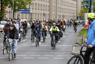 A policewoman from the Berlin bicycle squadron accompanies the bike parade demonstration, Berlin,