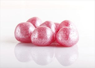 Heap of pink hard sugar candies isolated on white background