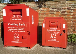 Red British Heart Foundation charity collecting containers for clothing, books and music, UK